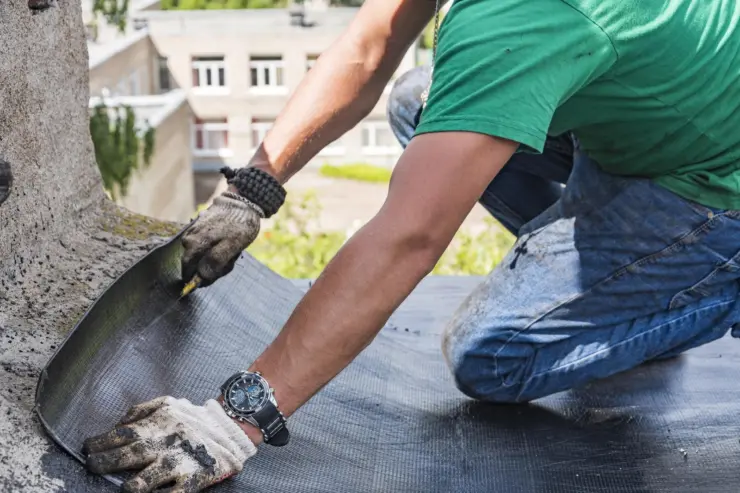 contractor installing residential roof waterproofing system