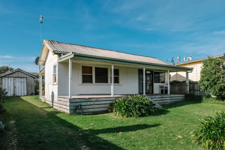 Small home that has an exterior termite barrier around the house